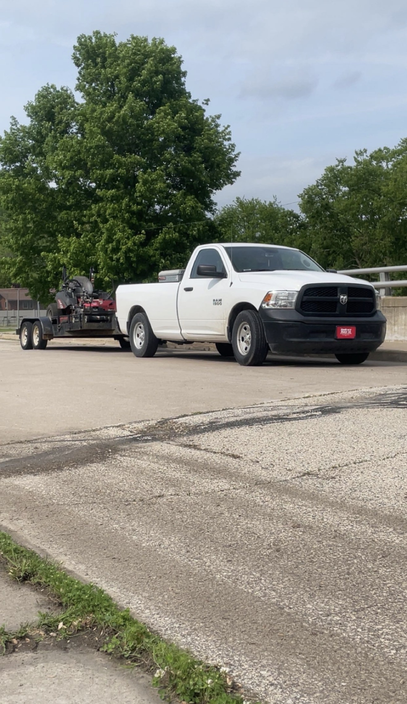 Quality Lawn Care pickup and mower trailer ready for a mow